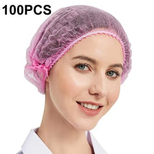 A woman is modeling a purple disposable non-woven bouffant cap with an elastic band on her head.