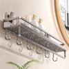 A silver wall-mounted shower caddy with suction cups holds several white soap bottles.