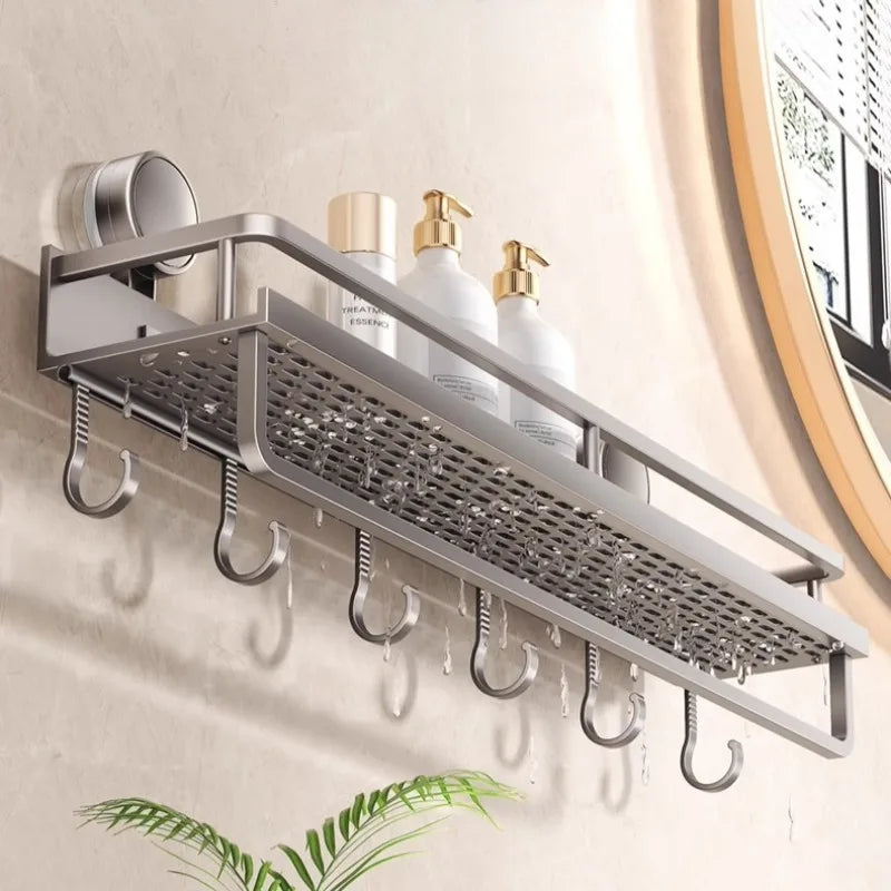A silver wall-mounted shower caddy with suction cups holds several white soap bottles.