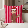 A red and pink striped pillow featuring a cartoon monkey dressed in a Santa hat.