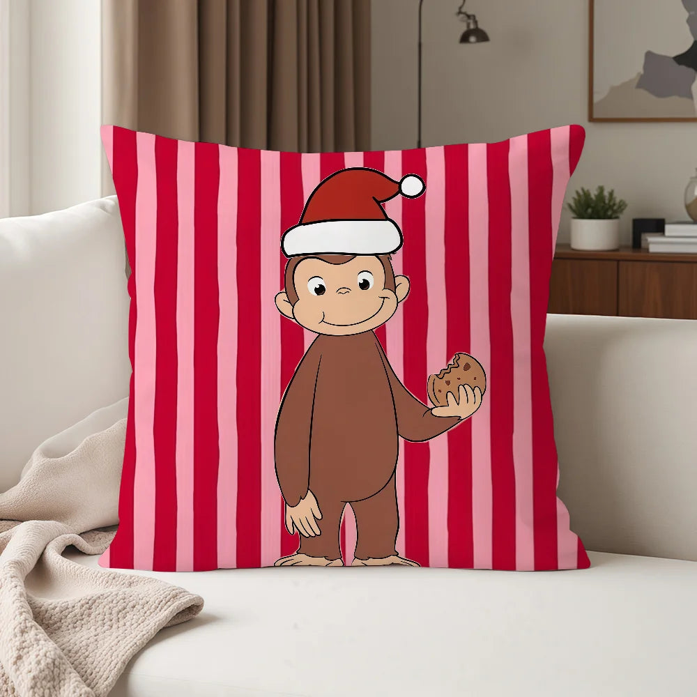 A red and pink striped pillow featuring a cartoon monkey dressed in a Santa hat.