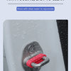 Close-up of a red silicone door shock-absorbing pad attached to a car door, with water droplets visible.