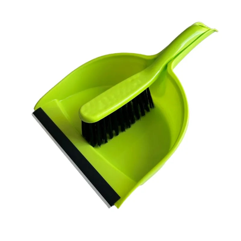 A bright lime green compact handheld dustpan and brush set with a black edge.