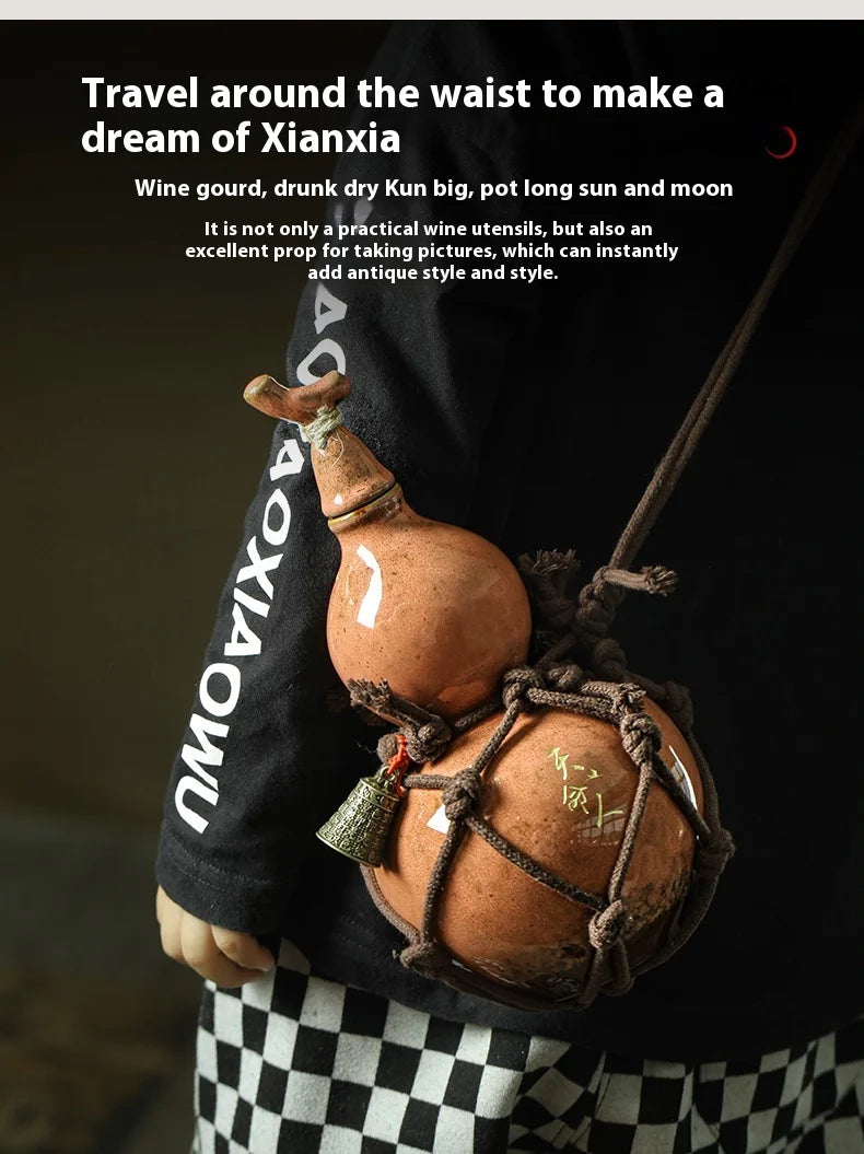 A person holds a handcrafted ceramic gourd wine set with a net bag, featuring an antique style.