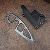 A compact stainless steel neck knife with a black sheath resting on a wooden surface.