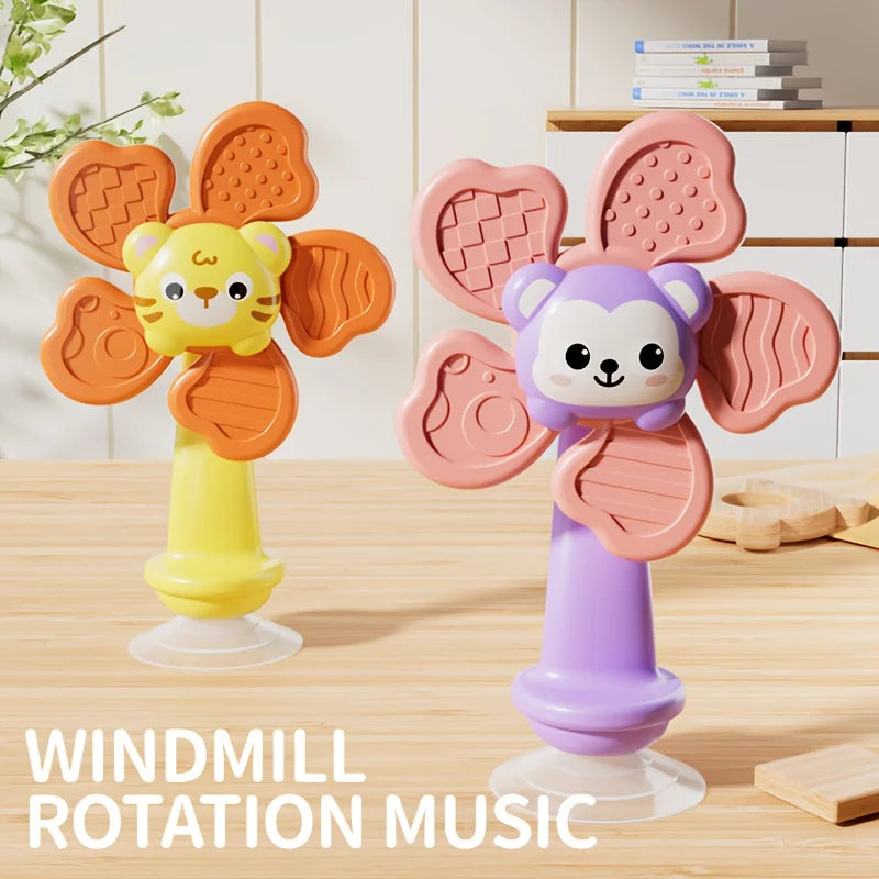 A set of pink and orange windmill rotation music toys shaped like a lion and a monkey, featuring suction cups.