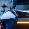Close-up of an amber LED grille light on a black Ford Ranger Raptor, showing off-road context.