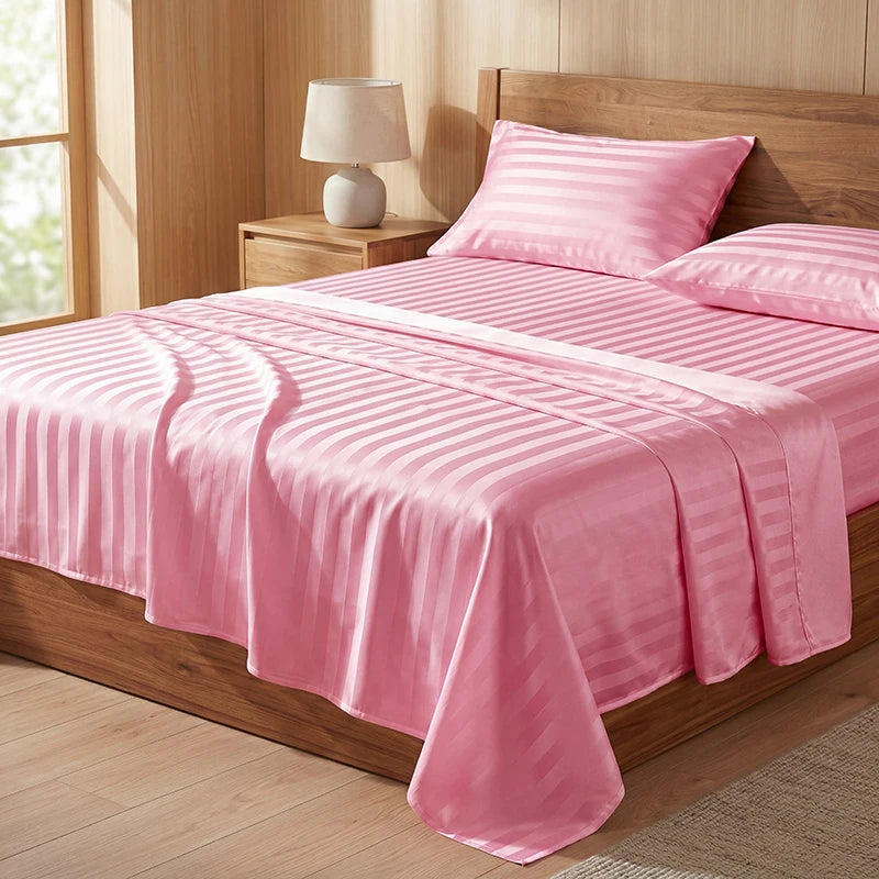 Pink striped satin bedding set featuring a fitted sheet, flat sheet, pillowcases, and duvet cover on a wooden bed.