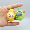 A hand holds a yellow Usagi and green Hachiware PVC bag pendant doll with string.