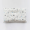 A white baby pillowcase featuring a pattern of gray and blue mountain shapes.