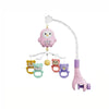 A pink musical baby crib mobile featuring a owl top and several small animal charms hanging from a curved light fixture.