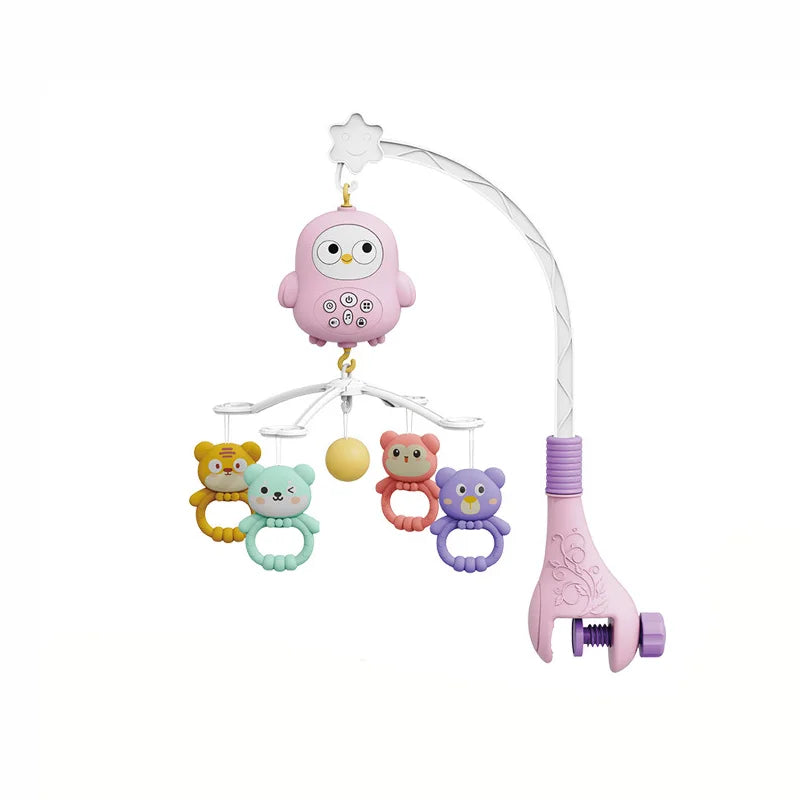 A pink musical baby crib mobile featuring a owl top and several small animal charms hanging from a curved light fixture.