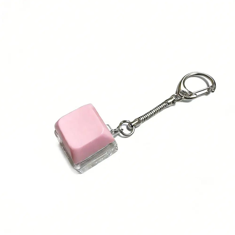 A pink, square mechanical keyboard fidget keychain with a silver chain and clasp.