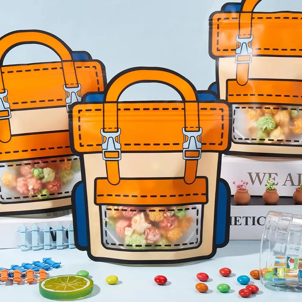 Orange and blue cartoon backpack goodie bags for kids party favors displayed on a white surface.