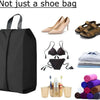 A black foldable nylon shoe storage bag is shown next to various shoes and accessories.