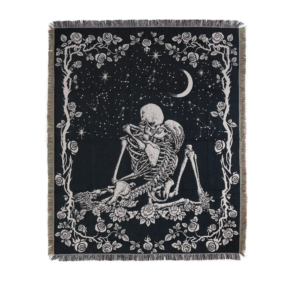 A dark fabric throw blanket featuring a white line art design of a skull, branches, and a crescent moon against a starry back