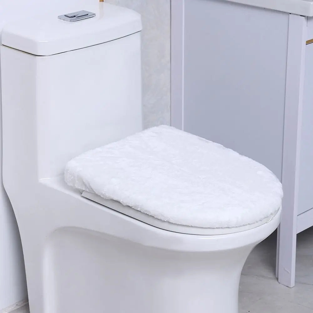 A white toilet features a soft, white flannel seat cover installed on the bowl.
