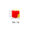 A red and yellow flexible silicone travel jar with a white measuring line, labeled 2ML / 5g.