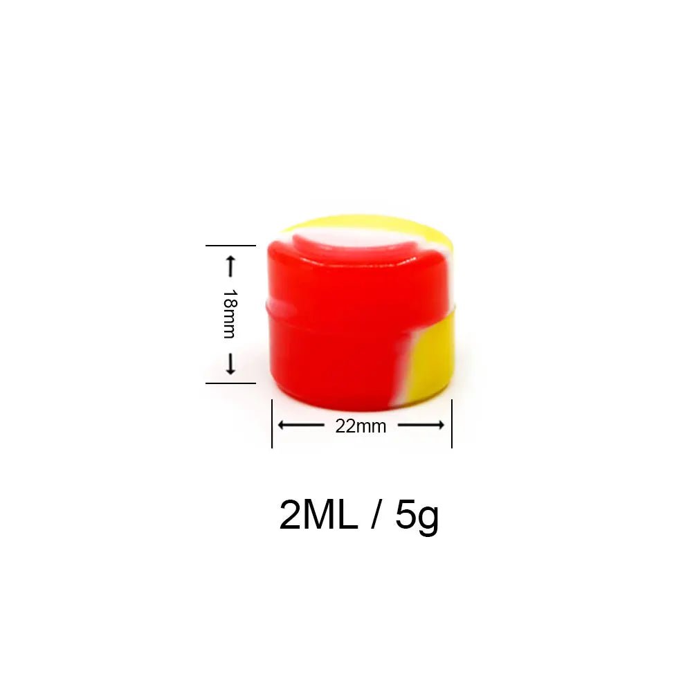 A red and yellow flexible silicone travel jar with a white measuring line, labeled 2ML / 5g.