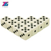 A set of ten white plastic game dice with black dots, branded T&G.