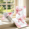 A pink lily flower tablet case with a pen holder is displayed on a windowsill next to a smartphone.