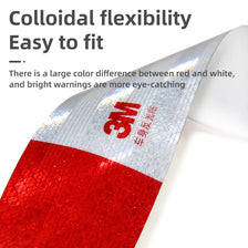 Close-up of a red and white reflective decal showing the 3M logo on a flexible material.