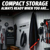 A black microfiber car drying towel is hanging on a white tiled wall next to various car tools.