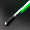 A silver lightsaber with a green blade and black grip is shown diagonally against a dark background.