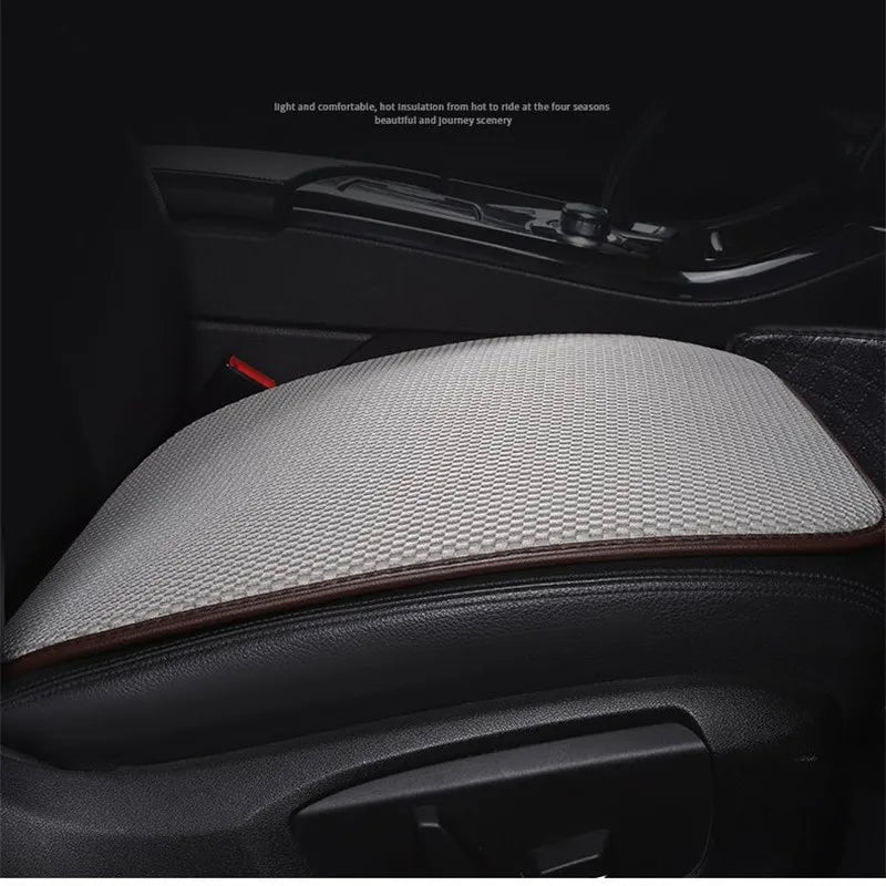 Close-up view of a gray breathable ice silk car seat cushion installed in a vehicle interior.