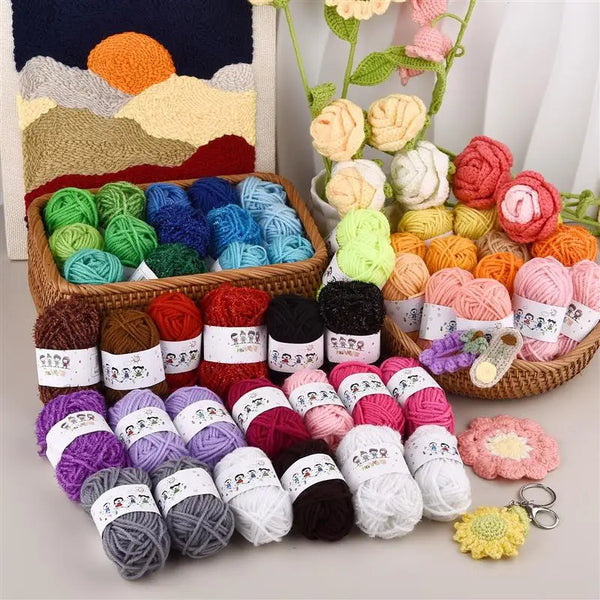 A collection of 12-color soft acrylic yarn skeins in various shades of green, blue, pink, and yellow arranged in a wooden bas