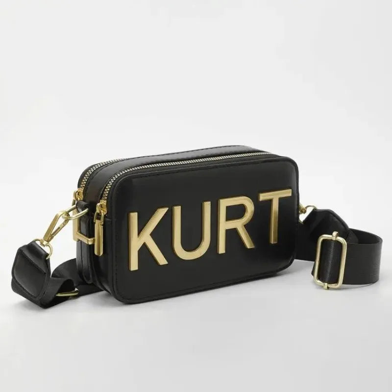 Schwarze Ledertasche mit goldenen Aufschriften und einem schwarzen Riemen