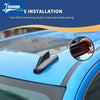 A hand is peeling off double-sided tape from a chrome-style car antenna cover trim on a blue vehicle.