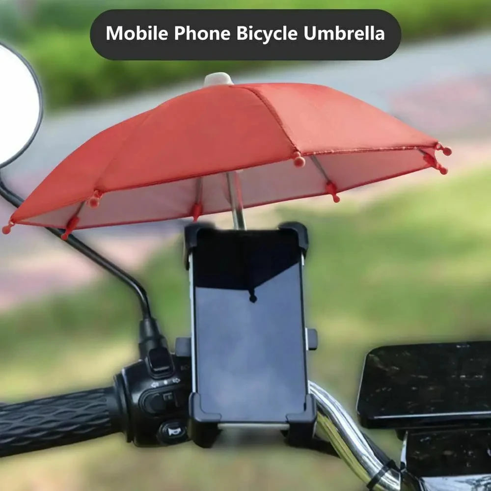 A red umbrella is mounted on a bicycle handlebar, protecting a smartphone from the sun.