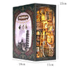 A dark wooden display box featuring a film-themed diorama and various small wooden puzzle books inside.