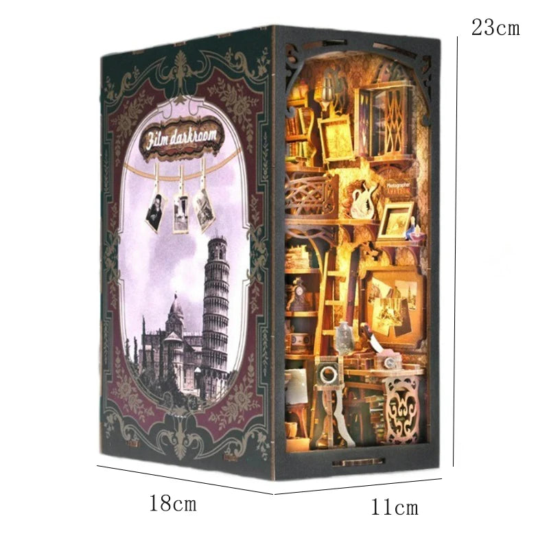 A dark wooden display box featuring a film-themed diorama and various small wooden puzzle books inside.