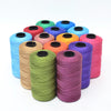A collection of multicolored 3-ply polyester knitting yarn spools in various shades including blue, green, orange, and pink.