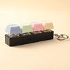 A black LED mechanical keychain fidget toy featuring colorful custom keycaps.