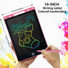 A hand holds a 10-inch pink LCD writing tablet displaying a green drawing, with a pink stylus used for handwriting.