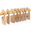 A set of wooden baby closet dividers used to organize clothing by size from newborn to 24 months.