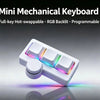 A white mini mechanical keyboard with RGB backlight and a round knob is shown on a reflective surface.