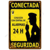 Vintage metal tin sign with yellow background and black text indicating a 24-hour alarm connection for security.