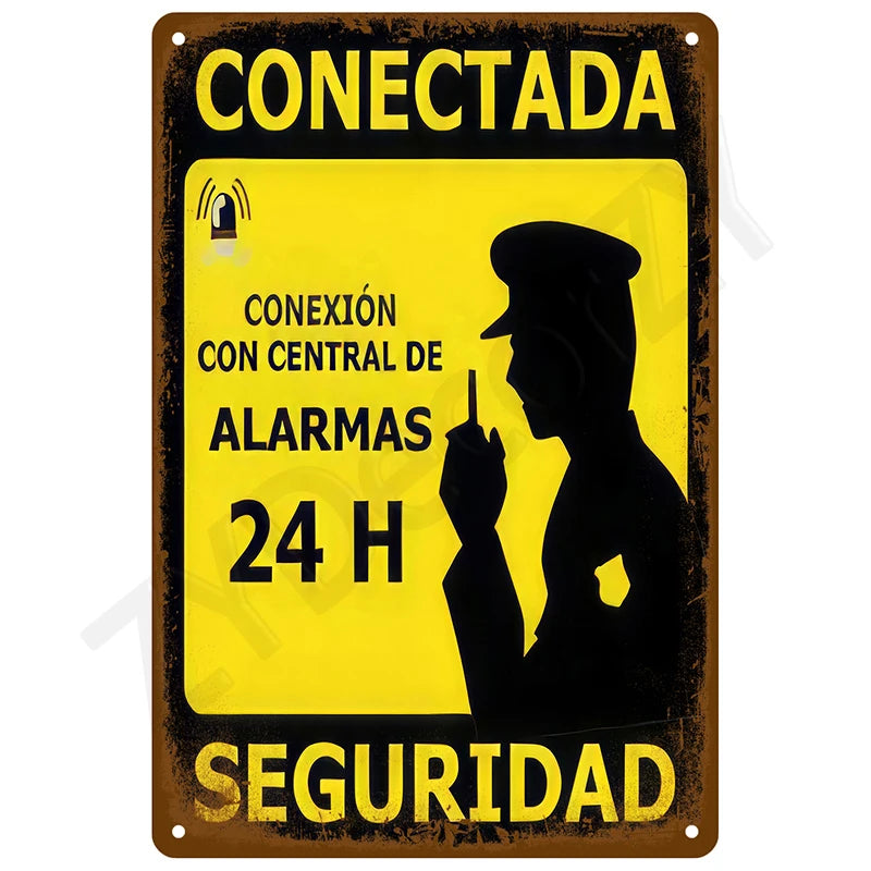 Vintage metal tin sign with yellow background and black text indicating a 24-hour alarm connection for security.