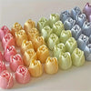 A row of pastel colored 3D tulip silicone molds for candle and soap making in various shades of pink, yellow, green, and blue