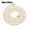 A strand of small, round, off-white pearls on a gold-toned chain.