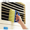 A hand is using a blue dusting brush to clean the slats of a window blind or vent.