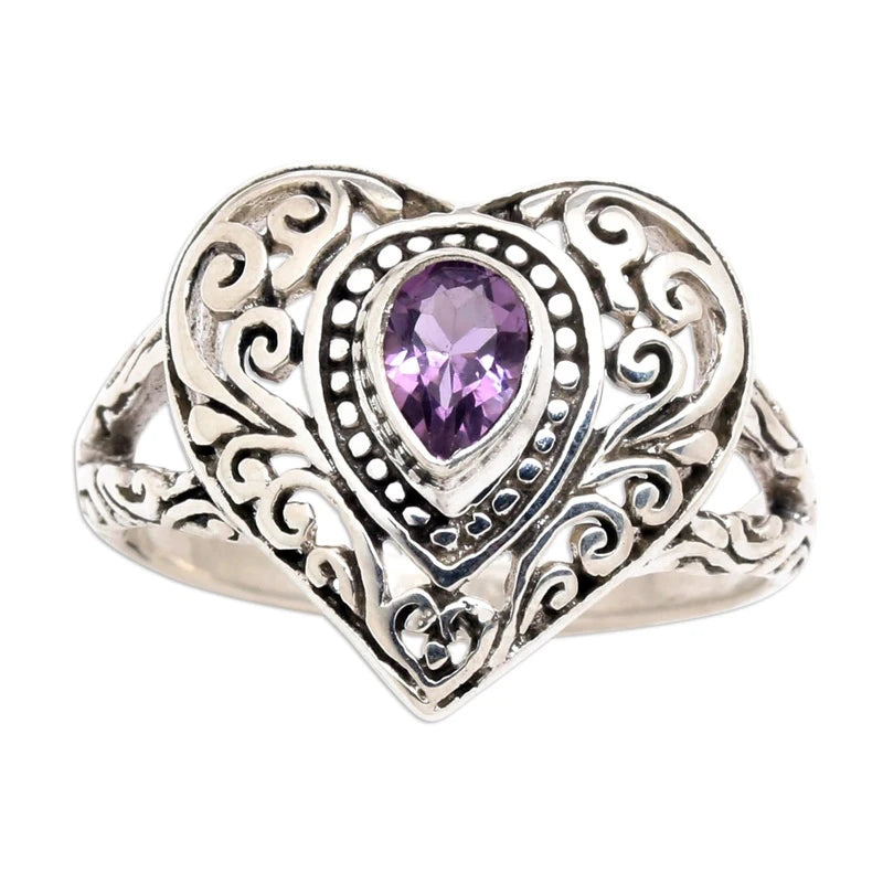 Vintage heart ring featuring a silver setting and a purple cubic zirconia stone.