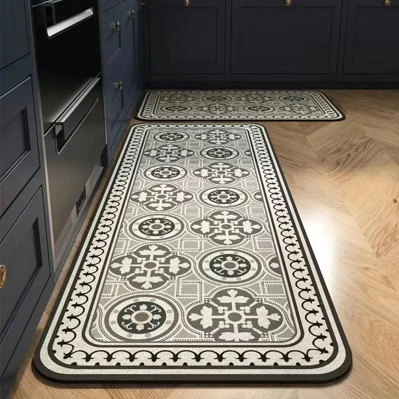 A long rectangular kitchen rug with a classic black and white Persian-style pattern is displayed on a wooden floor.