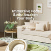 A white foldable foot bath tub with a lid is shown in the foreground on a wooden surface.
