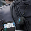 A black AirPods Pro case with a magnetic locking lid is shown attached to a dark gray backpack.