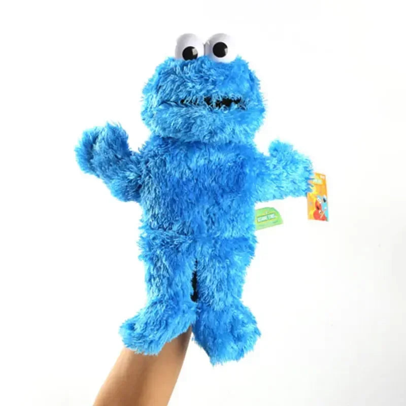 A bright blue Elmo hand puppet made of soft plush fabric being held by a person.
